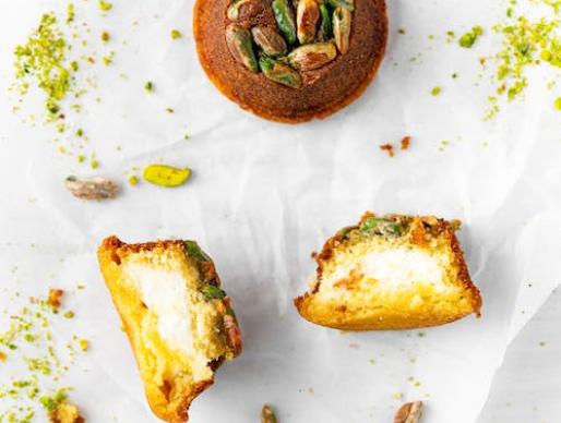 Brush pistachio pesto on bottom of a serving plate and top with arugula